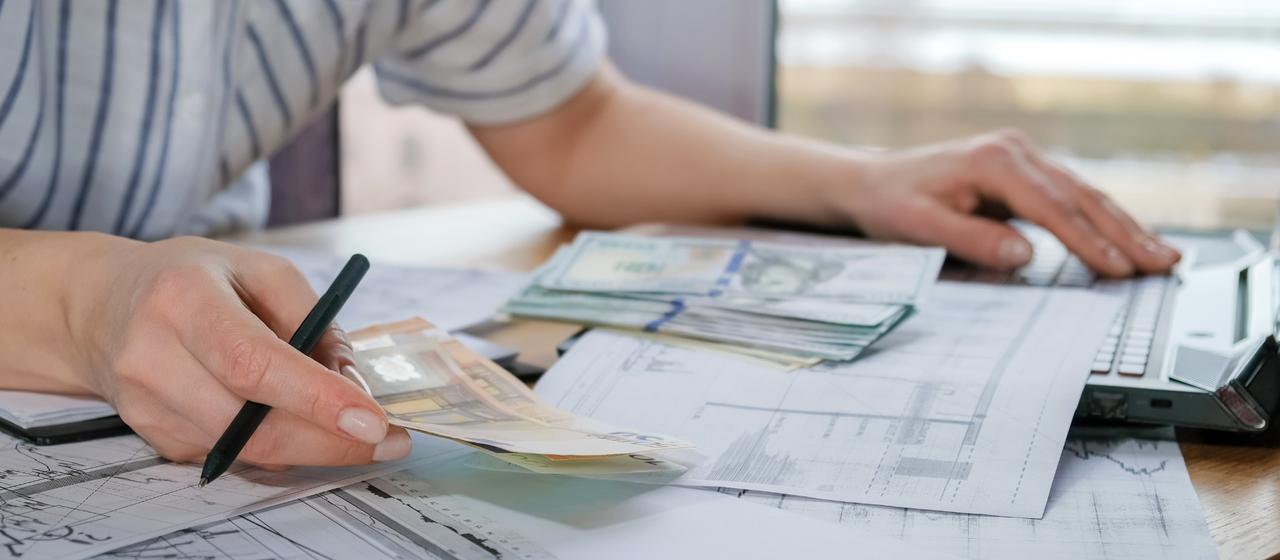 BC business owner reviewing a shareholder loan account ledger with a clock indicating the one-year section 15(2) repayment deadline.